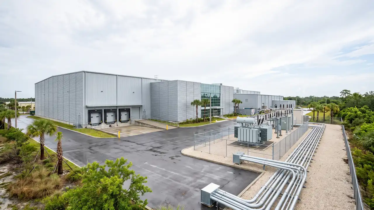 Modern industrial warehouse with loading docks and an electrical substation, Florida