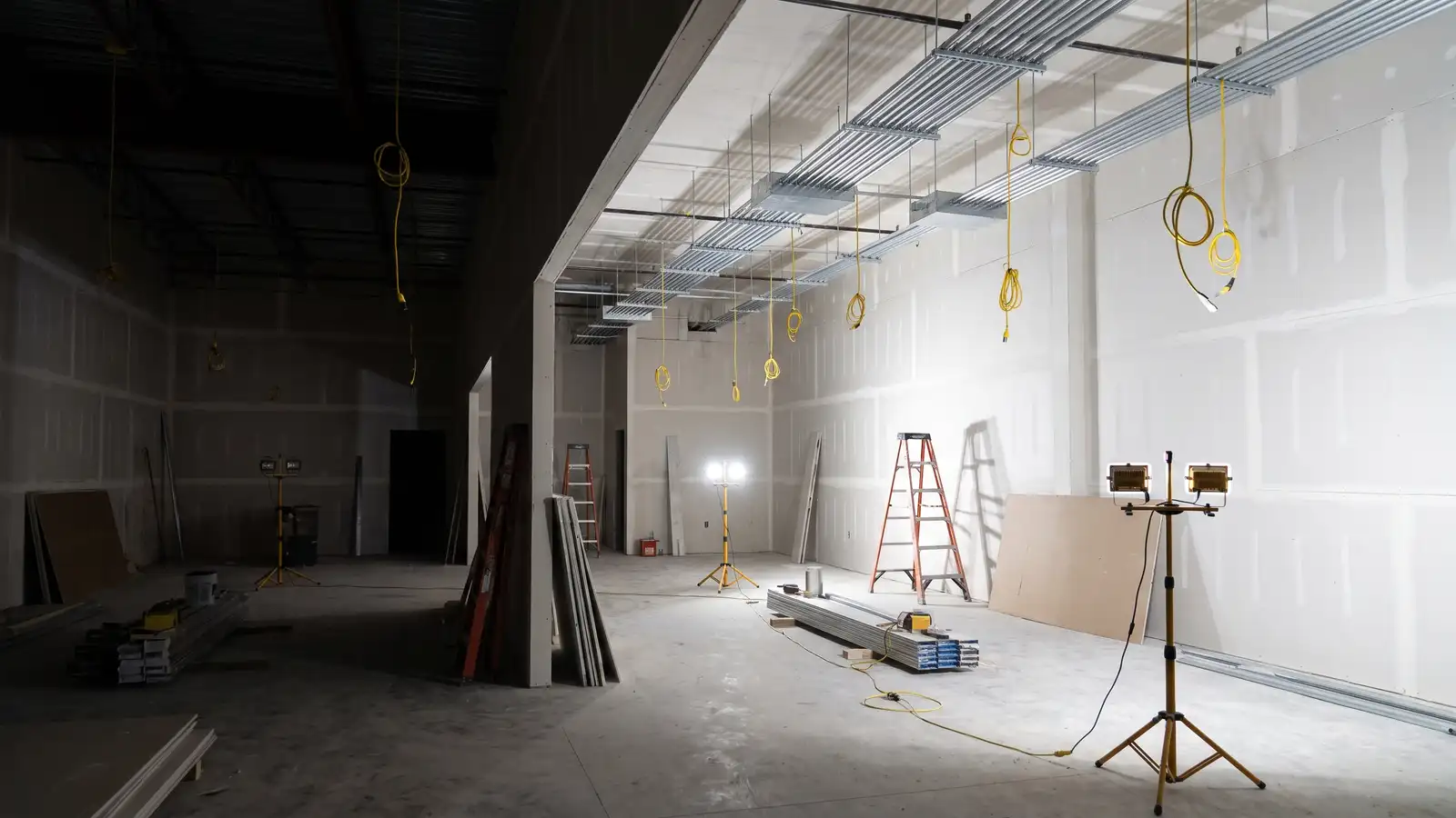 Empty commercial retail space with new conduit and boxes in the open ceiling