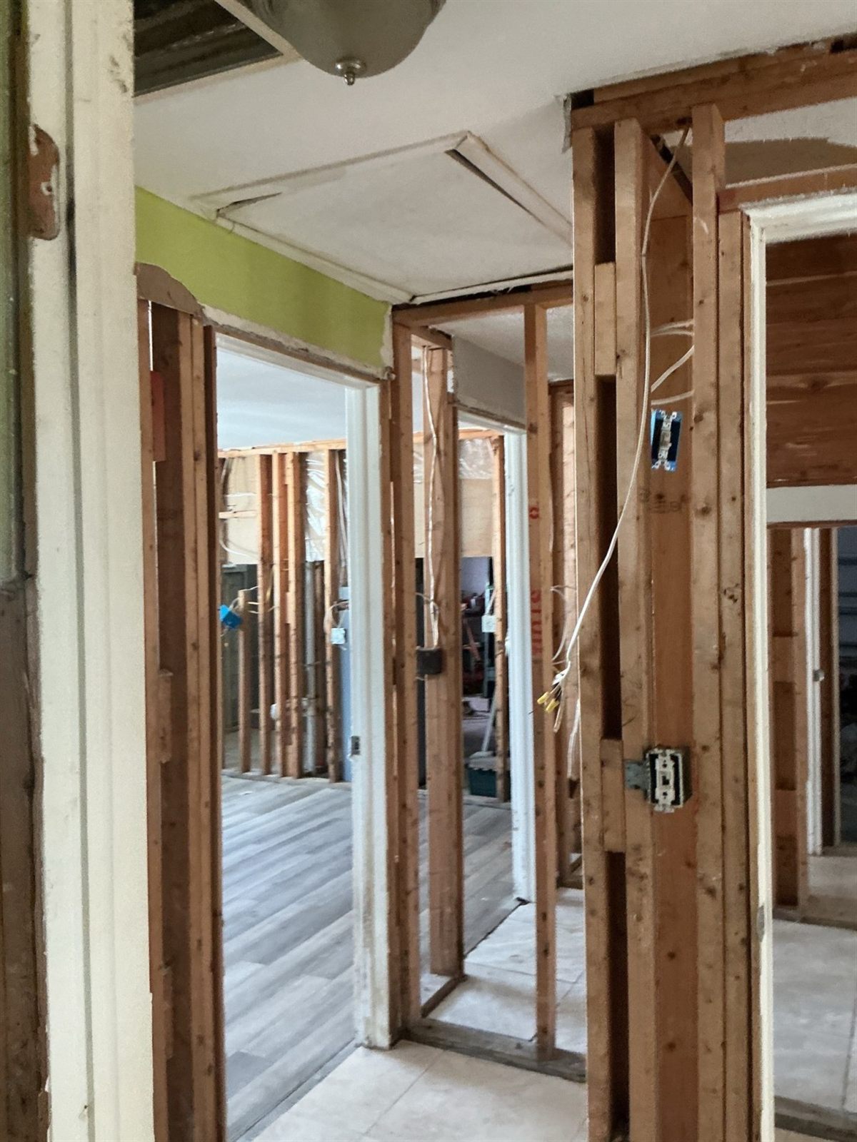 Interior walls opened to the framing with new electrical cable run through the studs and a new switch box installed